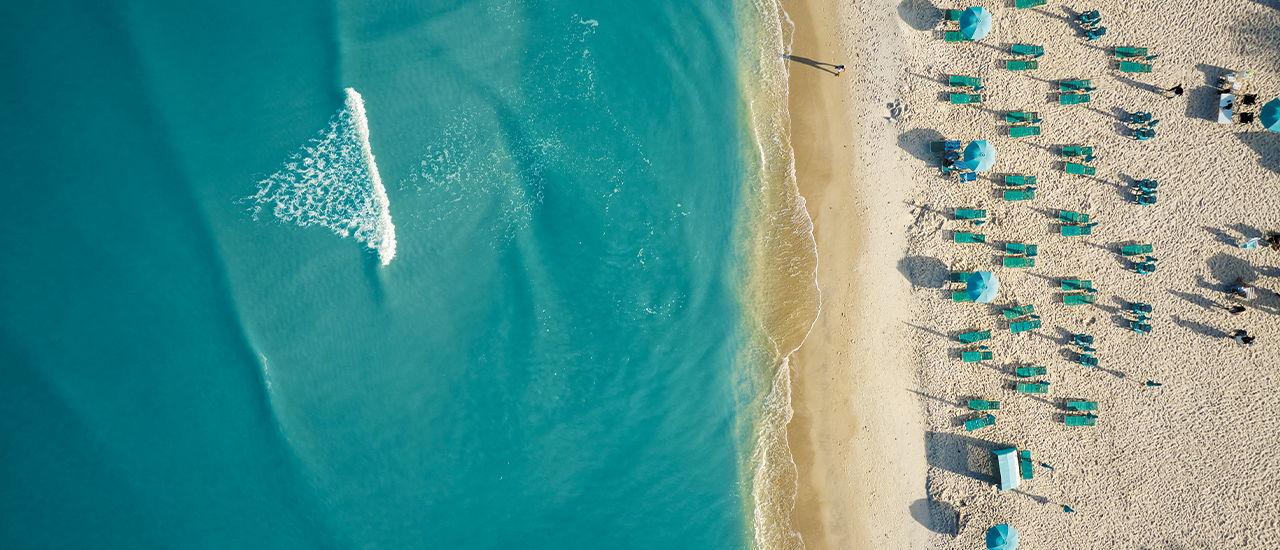 Aerial View of Beach with Turquoise Water and Sun Loungers