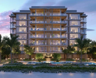 Oceanfront luxury residences with illuminated balconies at twilight