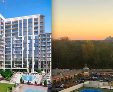 Modern apartment building near city skyline at sunset