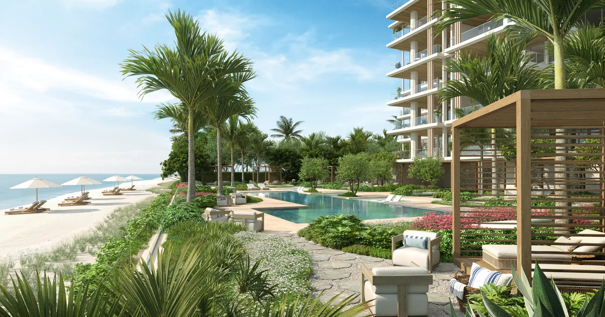 Rendering of a beachfront pool and cabana area next to a modern wood-and-glass residential tower, with lounge chairs and umbrellas on the sand and the ocean in the background.
